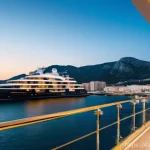 지브롤터 럭셔리 호텔 추천 - A luxurious, modern superyacht hotel docked in the vibrant Gibraltar port at golden hour. The image ...